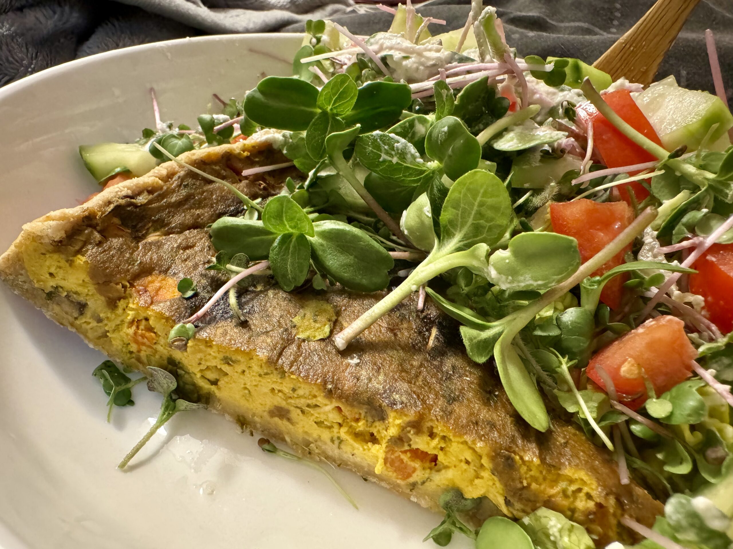 Plated quiche with fresh salad & house grown microgreens